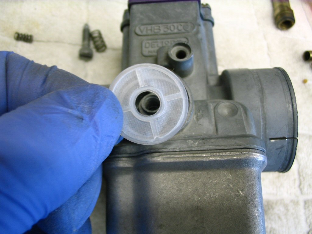 Fit a new plastic fuel filter to the carburetor fuel inlet. Note: the filters do not come with the carburetor kit and must be ordered separately.