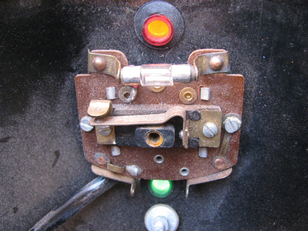Key switch and indicator lights at the top of the headlight bucket as fit to a Moto Guzzi Astore.