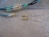 Female bullet terminals that will be connected to existing wiring inside the headlight bucket.