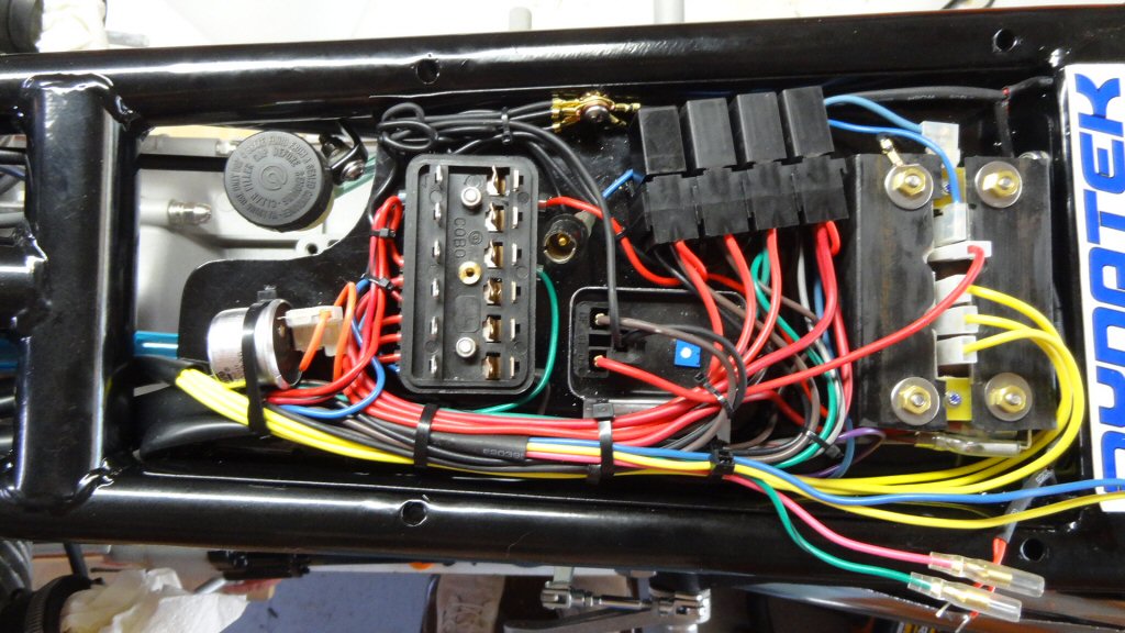 Here is the final tray in place with all of the wiring. It is a lot of wiring, but it all fits and functions perfectly. We also installed four relays: one each for the starter, headlights, coils, and horn.