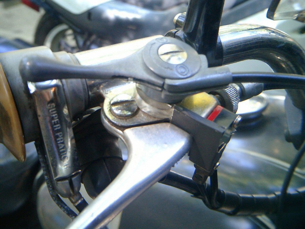 The brake switch installed. An alternative front brake light switch for drum brake Moto Guzzi V700, V7 Special, Ambassador, 850 GT, 850 GT California, Eldorado, and 850 California Police motorcycles.