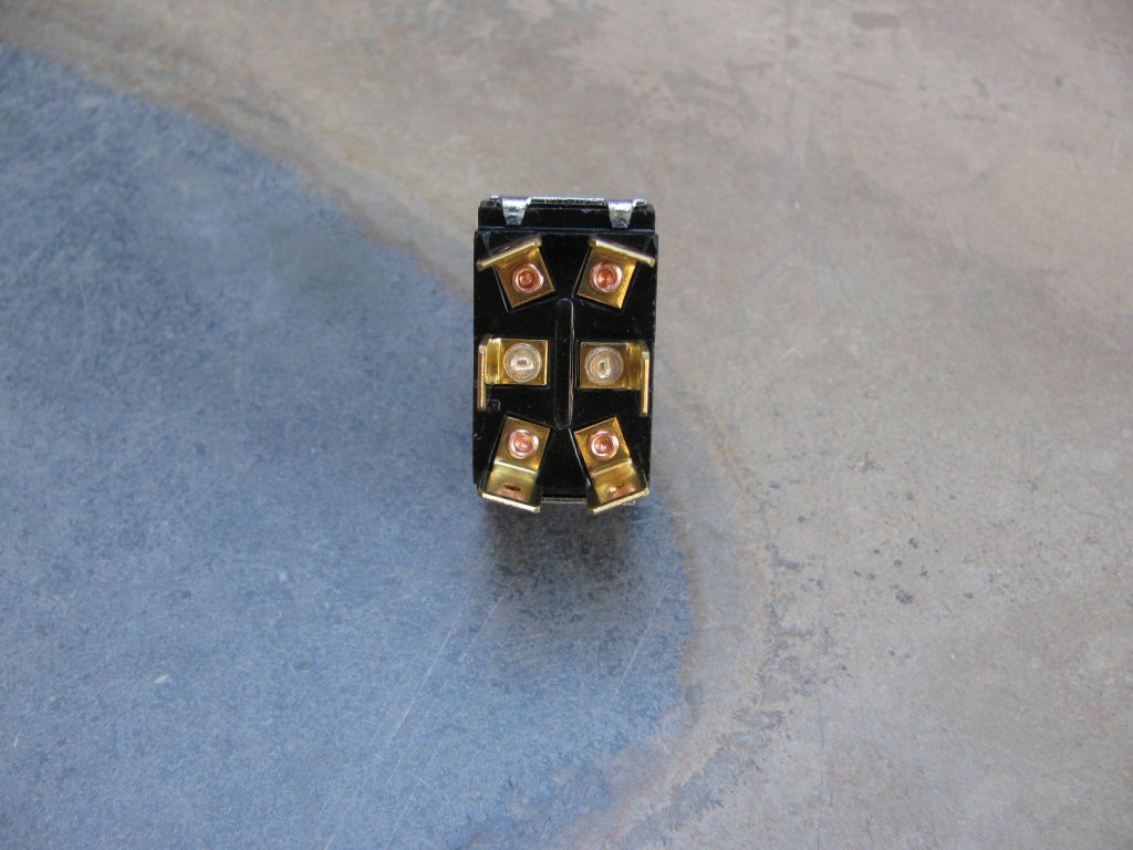 The terminals on the bottom of the toggle switch.