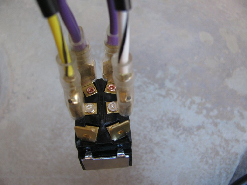 The white/black and yellow/black wires from the toggle switch to 3 connection female spade connectors sub-harness are connected to the middle terminals on the toggle switch.