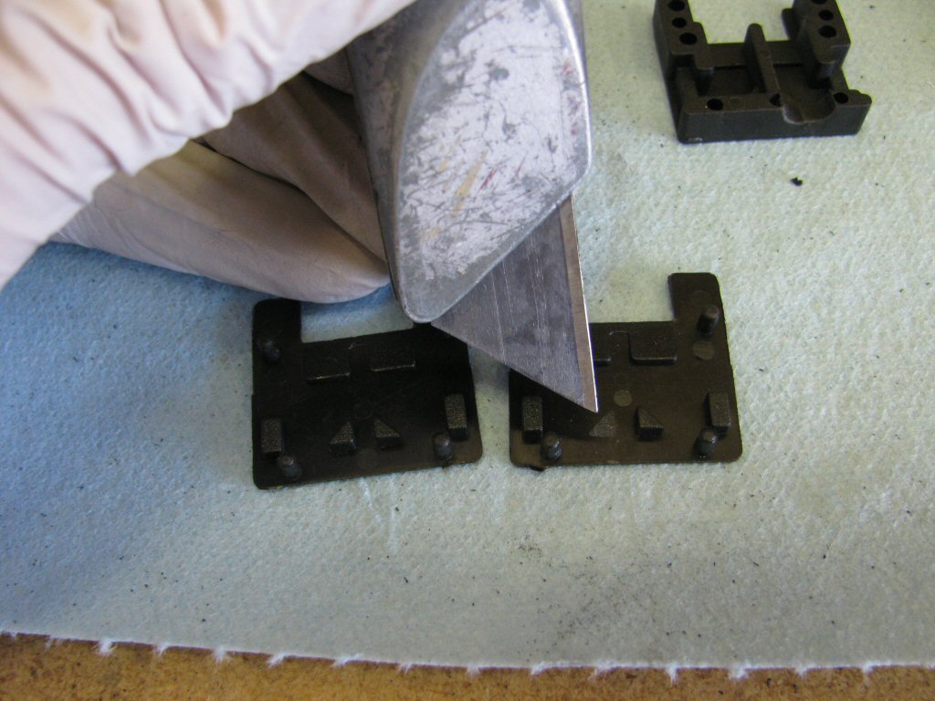 Turn your attention to the cover for each fuse holder. Remove this triangle with a sharp razor blade.