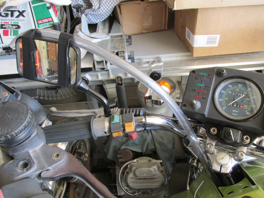 Large diameter hose coming straight off the crankcase, up under the tank, and taped to the left mirror for ease of visibility. Extremely ugly and only fit for a single test.