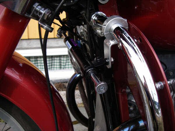 Joe Jump's steering damper kit fit to Frank Granli's motorcycle with leg shields.