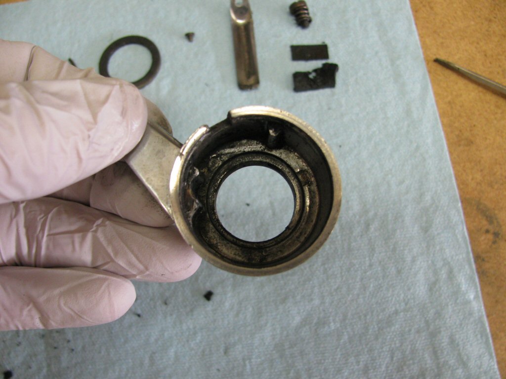 Empty throttle body. You can see the protrusions that keep the rubber friction material and metal backing plate from rotating when the throttle tube is rotated.