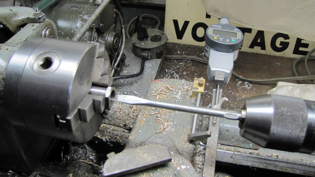 Using a lathe to lap the valve to its seat.